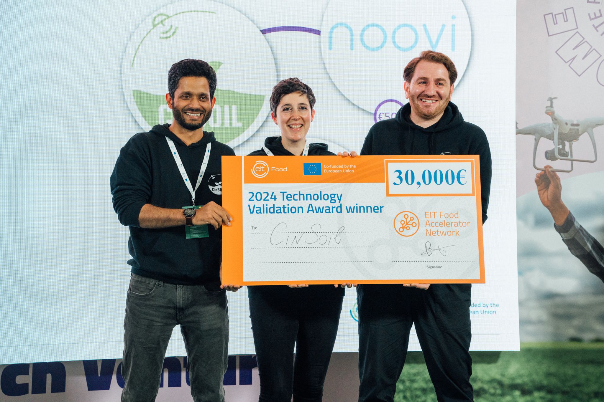 CinSOIL co-founders Tavseef, Antonella, Giorgi holding the 2024 Technology Validation Award check at the EIT Food Next Bite event in Rome